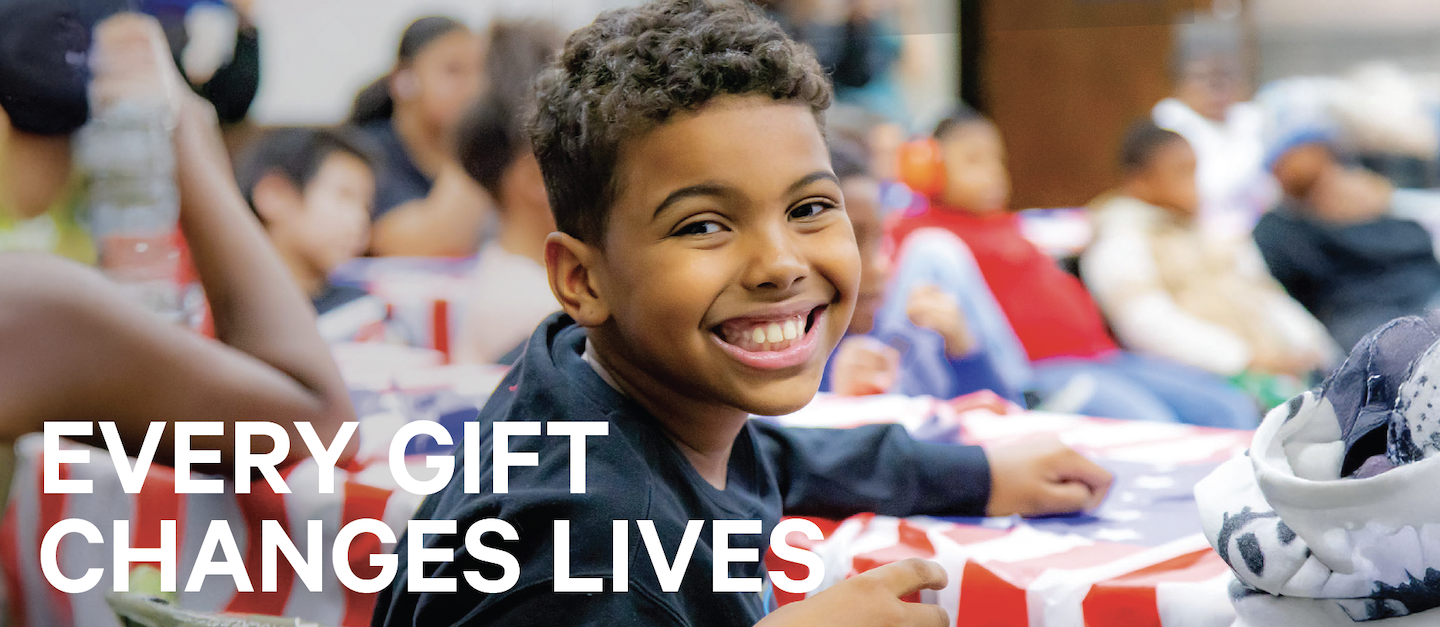Child in an afterschool civics program smiles at the camera. Text reads, "Every gift changes lives."